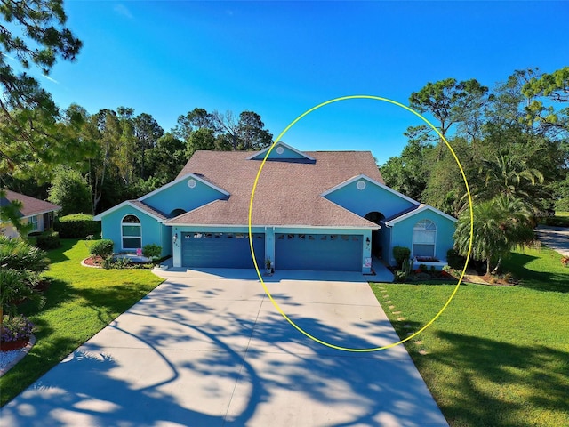 view of front facade featuring a front lawn and a garage