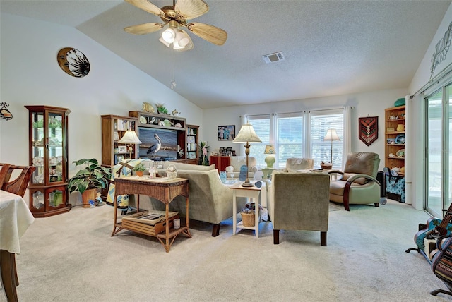 living room featuring a textured ceiling, high vaulted ceiling, ceiling fan, and light carpet