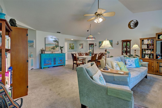 living room featuring light carpet, lofted ceiling, and ceiling fan