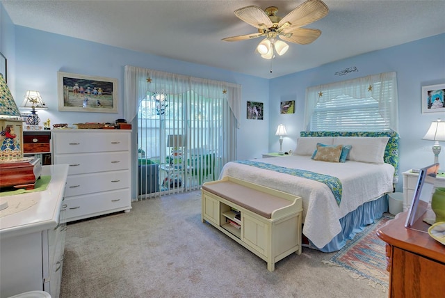 bedroom with ceiling fan and light carpet