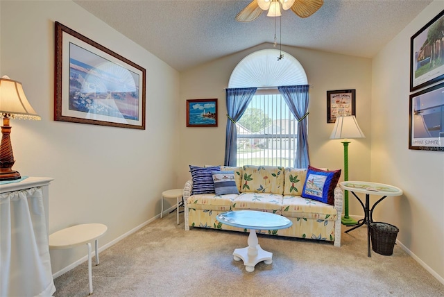 living area featuring light colored carpet, lofted ceiling, and a textured ceiling