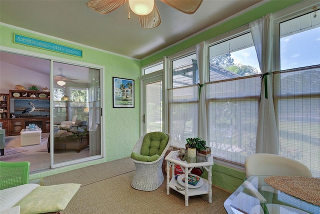 sunroom featuring ceiling fan