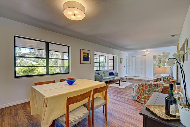 dining area with hardwood / wood-style floors