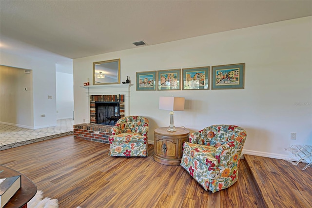 living room featuring a fireplace and wood-type flooring