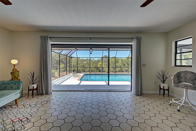 interior space featuring a healthy amount of sunlight, ceiling fan, and a textured ceiling