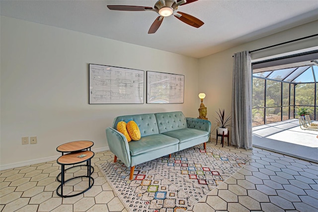 living room with a textured ceiling, ceiling fan, and light tile patterned floors