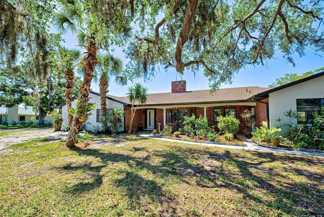 single story home featuring a front lawn