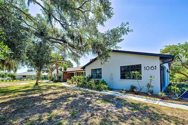 view of side of home featuring a yard