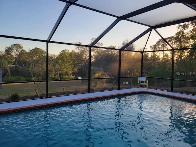 view of pool with glass enclosure