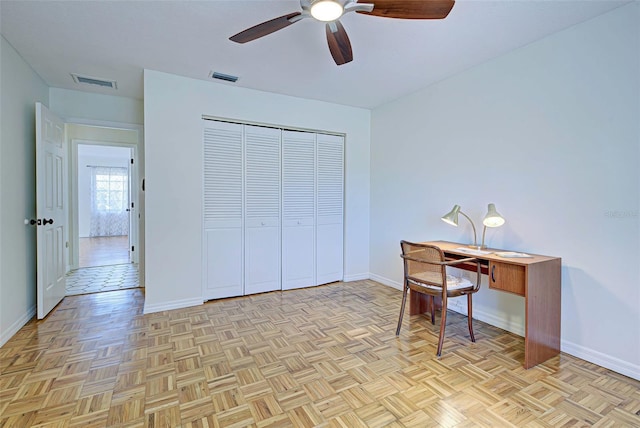 office with ceiling fan and light parquet floors