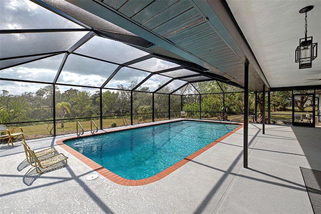 view of swimming pool with a patio area and glass enclosure