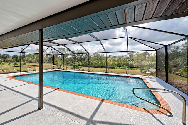 view of swimming pool with glass enclosure and a patio