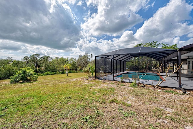 view of yard featuring glass enclosure and a patio