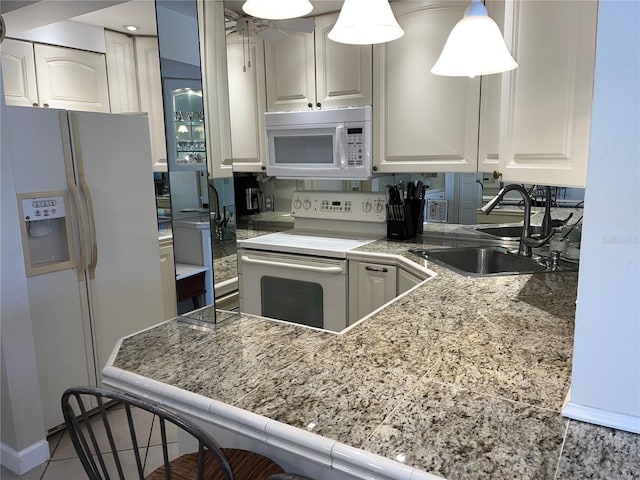 kitchen featuring kitchen peninsula, white appliances, white cabinetry, and sink