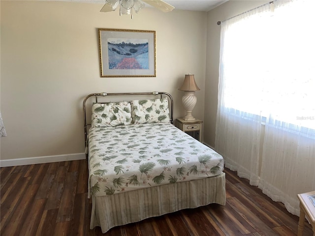 bedroom with ceiling fan and dark hardwood / wood-style floors