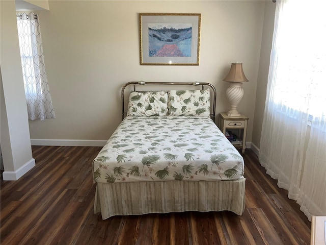 bedroom featuring dark hardwood / wood-style floors and multiple windows