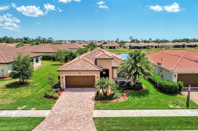 mediterranean / spanish home with a garage and a front lawn