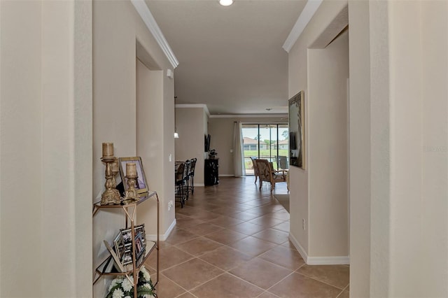 hall with ornamental molding and light tile flooring