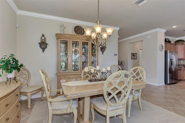 tiled dining area featuring a notable chandelier and crown molding