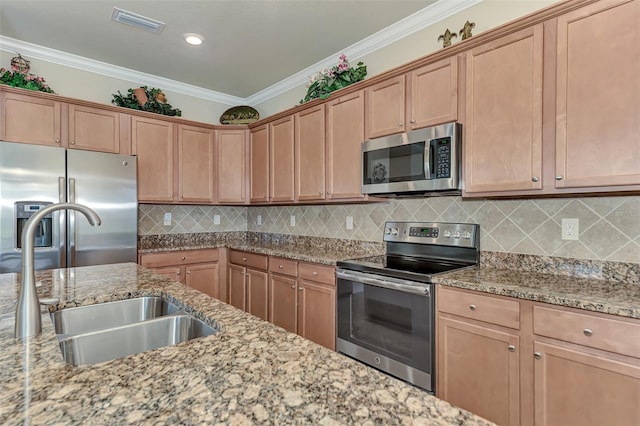 kitchen featuring appliances with stainless steel finishes, tasteful backsplash, light stone countertops, and sink