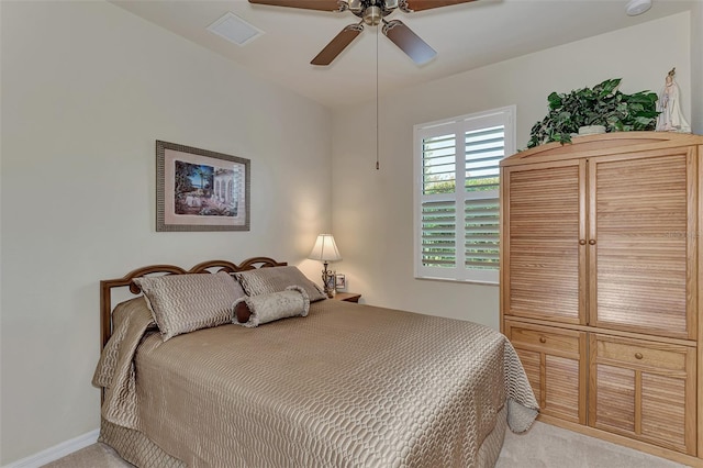 bedroom with ceiling fan and light carpet