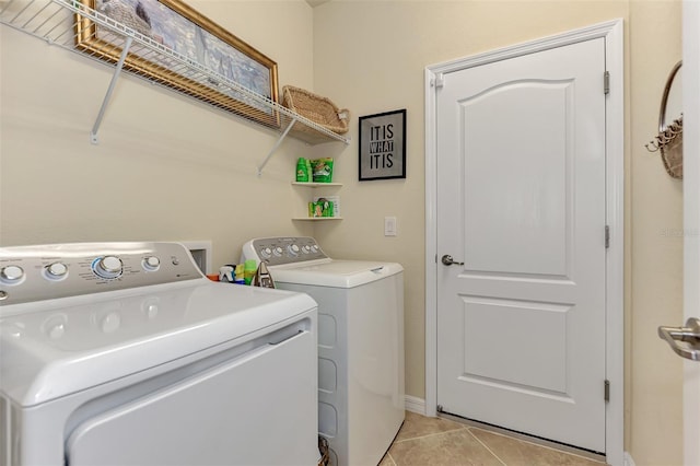 washroom with independent washer and dryer and light tile flooring