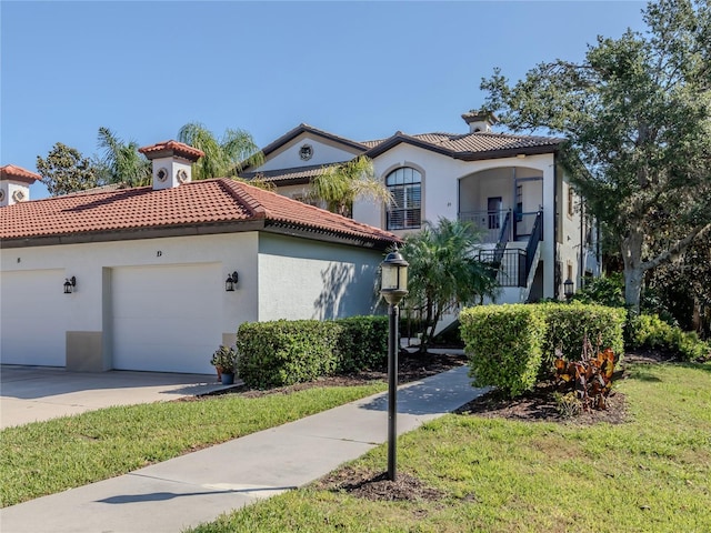 mediterranean / spanish house with a front yard and a garage