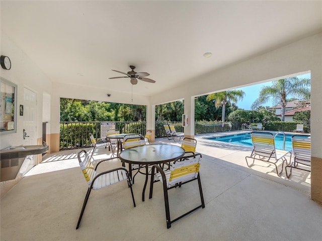 view of patio featuring a fenced in pool and ceiling fan