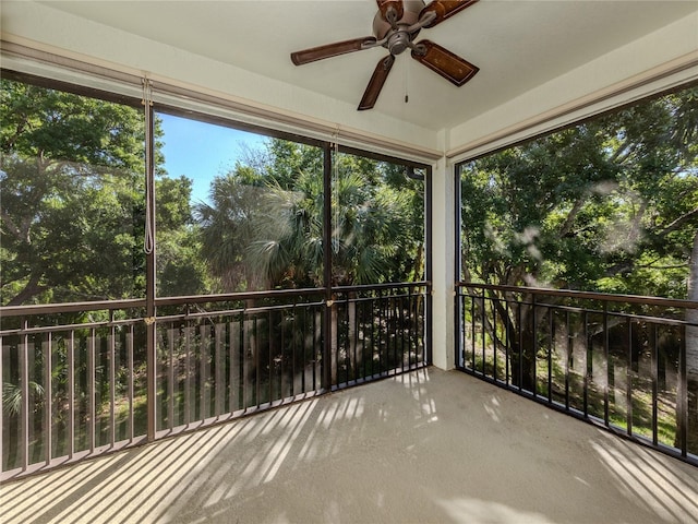 unfurnished sunroom with ceiling fan