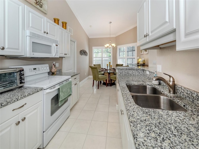 kitchen featuring sink, white appliances, white cabinets, and hanging light fixtures