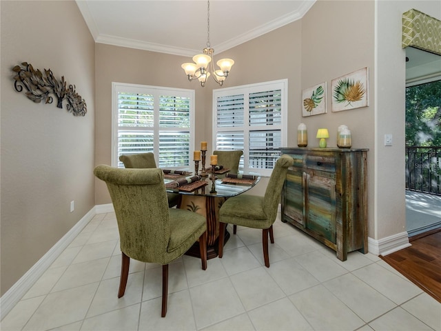 tiled dining room featuring ornamental molding and a chandelier