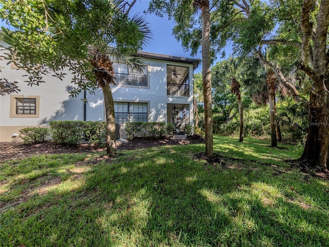 exterior space with a balcony and a yard