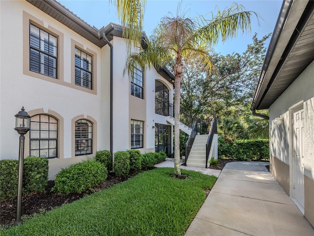 view of side of home with a lawn