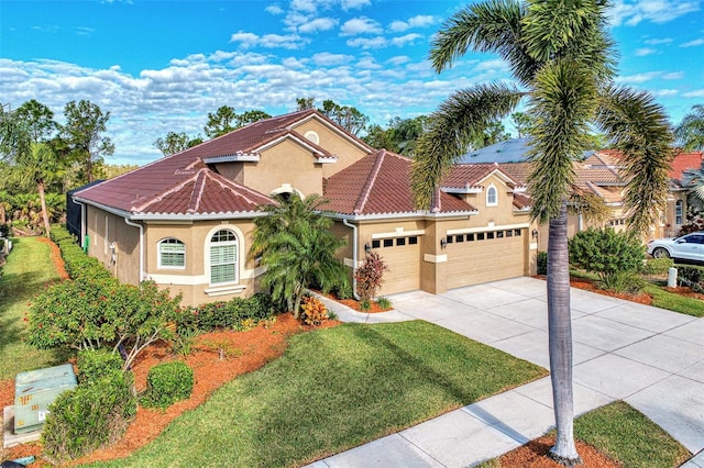 mediterranean / spanish house with a garage and a front yard