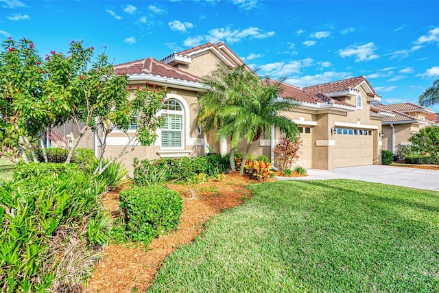 mediterranean / spanish home featuring a garage and a front yard