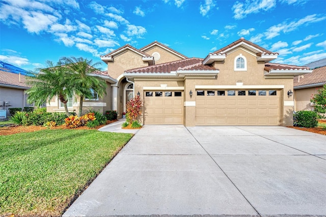 mediterranean / spanish-style house with a garage and a front yard