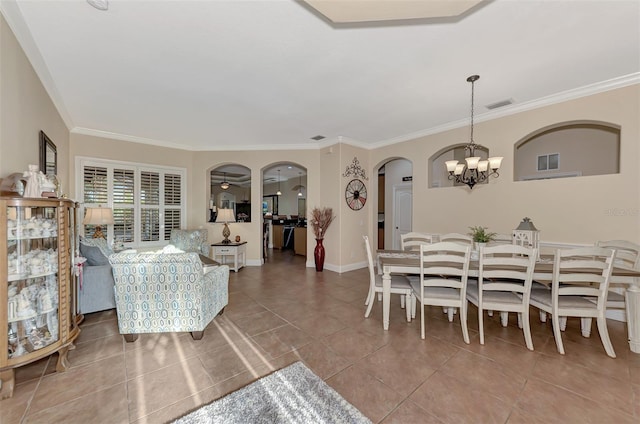 tiled dining room featuring an inviting chandelier and crown molding