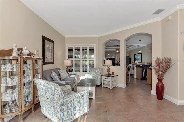 tiled living room with ceiling fan and ornamental molding