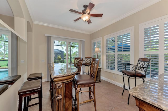 dining space featuring a wealth of natural light, ceiling fan, and tile patterned flooring