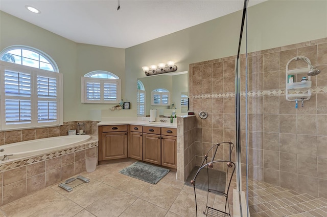 bathroom with tile patterned floors, plus walk in shower, and vanity