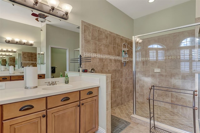 bathroom featuring a shower with shower door, vanity, and tile patterned flooring