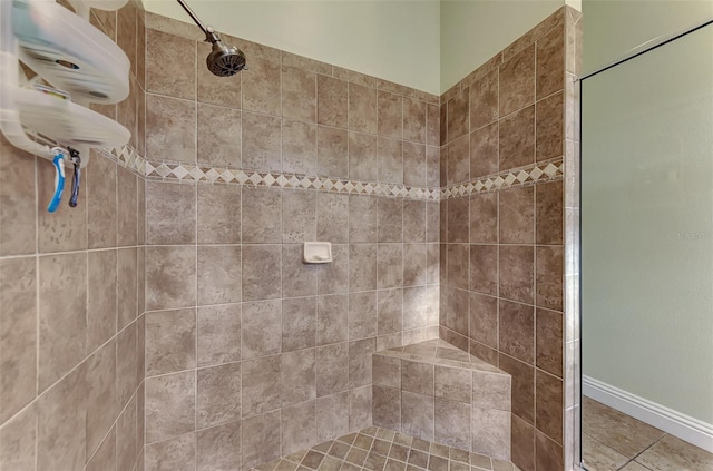 bathroom with a tile shower