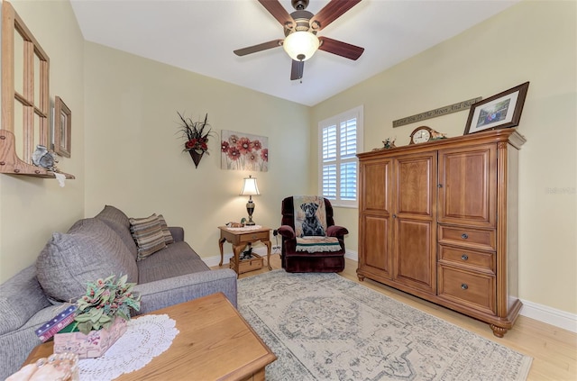 living room with light hardwood / wood-style floors and ceiling fan