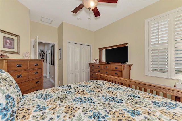 bedroom with tile patterned flooring, a closet, and ceiling fan