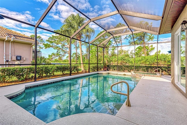 view of pool with glass enclosure