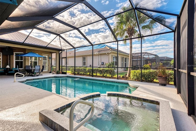 view of pool with a patio area and a lanai