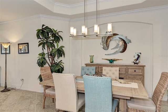 dining space featuring crown molding, light tile floors, and a tray ceiling