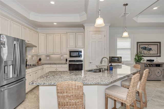 kitchen featuring light tile floors, sink, a raised ceiling, decorative light fixtures, and black appliances