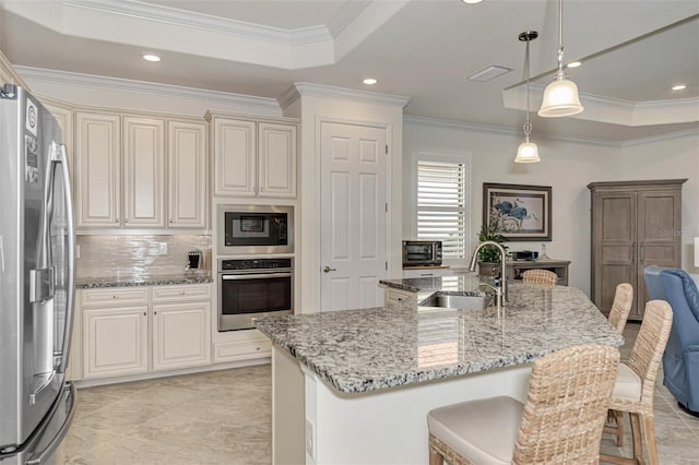 kitchen featuring pendant lighting, sink, light tile floors, a raised ceiling, and stainless steel fridge