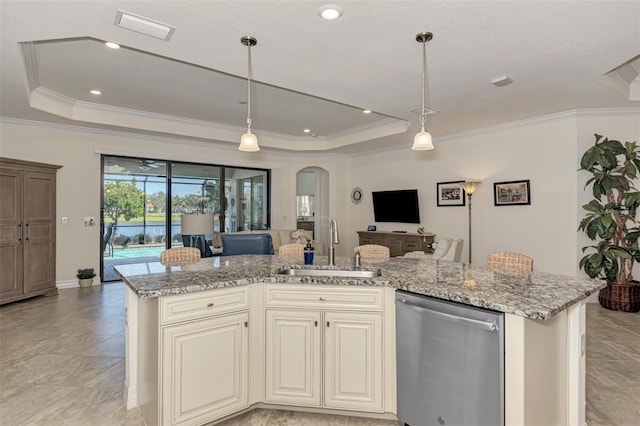 kitchen with stainless steel dishwasher, sink, a raised ceiling, and light stone countertops